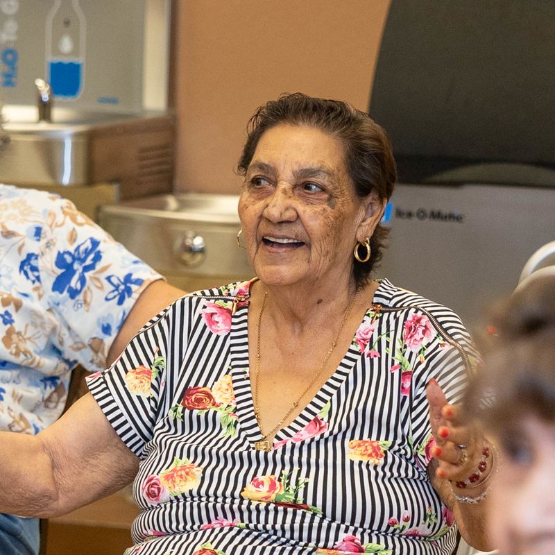 A participant laughs during a seated exercise.